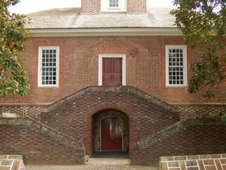 large brick house with symmetrical brick stairs in front