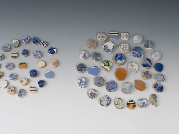 Shaped ceramic gaming pieces organized into circular arrangements