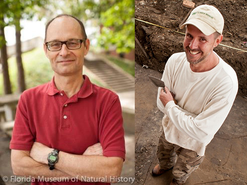 Two men posed with arms crossed, smiling at the camera, outdoors