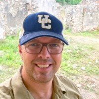 Man wearing a ball cap, taken outdoors
