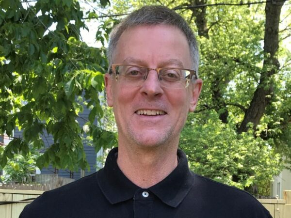 Man wearing glasses, posed outdoors