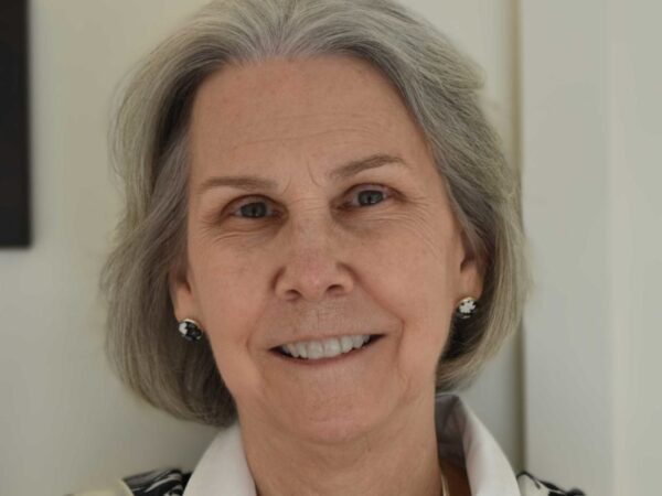 Close-cropped headshot of a woman with short gray hair