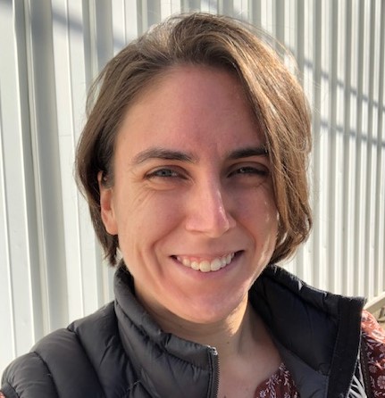 Woman smiling with a fence in background