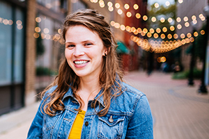 Woman wearing denim jacket in an urban area