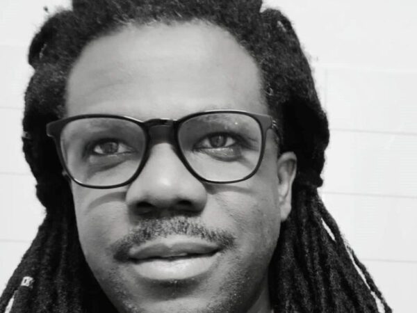 Close cropped image of a man with dreadlocks