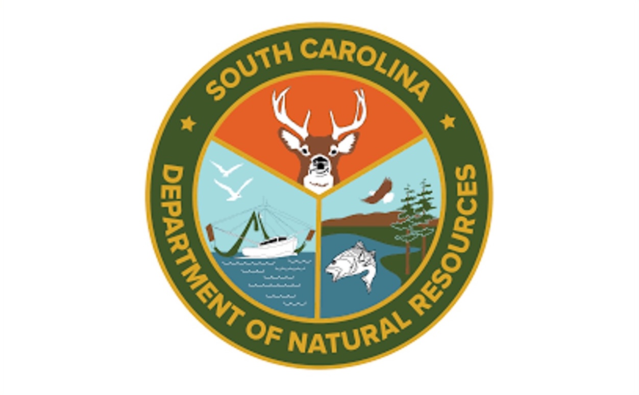 Logo of the South Carolina Department of Natural Resources, showing a deer, a boat, and a river