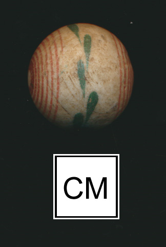 Marble with pale background and central green floral band, bordered by multiple plain red bands on both sides. Photographed on a black background with a centimeter scale.